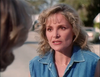 A blonde woman with a concerned expression talks to someone off-screen in a scene from the Murder So Sweet (1993) DVD.
