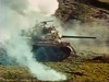 A tank shrouded in smoke advances across a grassy field with trees in the daylight background, evoking the gripping wartime suspense featured in the classic “Fireball Forward” (1972) DVD.