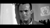 A man with a serious expression leans against a wall in a black and white scene, wearing a suit jacket and gazing intently forward—evoking the timeless atmosphere of “The World, The Flesh and the Devil” (1959) on DVD.