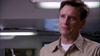 A man in a tan military-style shirt stands indoors, looking slightly to the side with a serious expression—creating a scene reminiscent of classic military family films. The fluorescent lights and blurred background evoke the atmosphere found in rare DVDs like Tiger Cruise (2004) DVD.