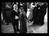 An elderly man and woman pause while dancing in a crowded ballroom, looking up as couples in formal attire dance around them—a scene reminiscent of those found in films like *Make Way For Tomorrow* DVD (1937).