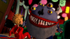A child in red pajamas faces a large blue monster with multiple eyes, sharp teeth, and a furry body in a colorful, cartoonish room—evoking the whimsical and spooky world found in Scary Godmother: The Revenge of Jimmy (2005) DVD, a classic film on DVD cherished by fans of imaginative adventures.