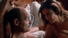 A man and woman lie in bed together, facing each other intimately in soft lighting. The woman gazes gently at the man, who returns her look, evoking the timeless romance of classic films like “Love, Murder and Deceit (1997)” on DVD.
