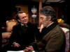 In a scene from The Strange Case of Dr. Jekyll and Mr. Hyde (1968) DVD, Jack Palance in a tuxedo speaks to a man in a textured jacket and glasses seated on a sofa.