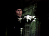 Jack Palance in formal wear and a top hat reaches out with a gloved hand toward the camera in a scene from The Strange Case of Dr. Jekyll and Mr. Hyde (1968) DVD.