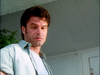 A man with dark hair looking downward with a serious expression, featured on the cover of the Murder So Sweet (1993) DVD, reminiscent of a character in a rare classic movie.
