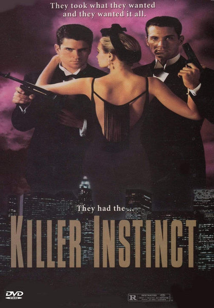 A woman in a black dress faces away, holding two pistols at tuxedoed men aiming guns. The Killer Instinct DVD (1992) title is displayed above a cityscape—classic crime movie vibes with a gripping mafia showdown.