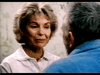An older woman with short, light hair smiles softly at an older man with gray hair and a beard, evoking the heartfelt senior care story featured in the "Amos (1985) DVD.