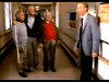 Three older men stand together in a hallway, two with arms around each other, as a fourth man in a suit approaches—a scene from the senior care drama "Amos (1985)" DVD, likely set in a hospital or care facility.